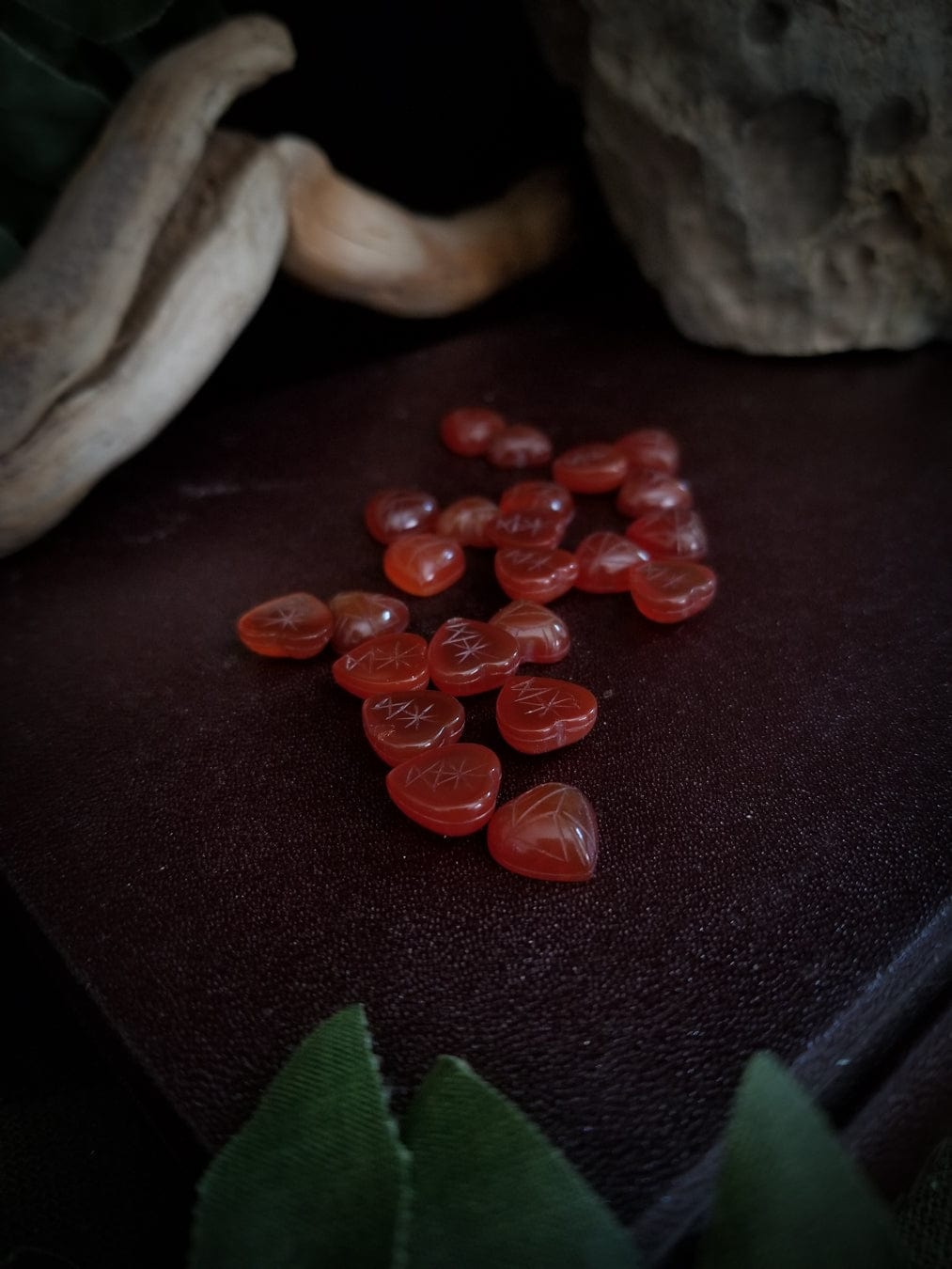 Red carnelian heart cabochons with carved scarab beetle designs.