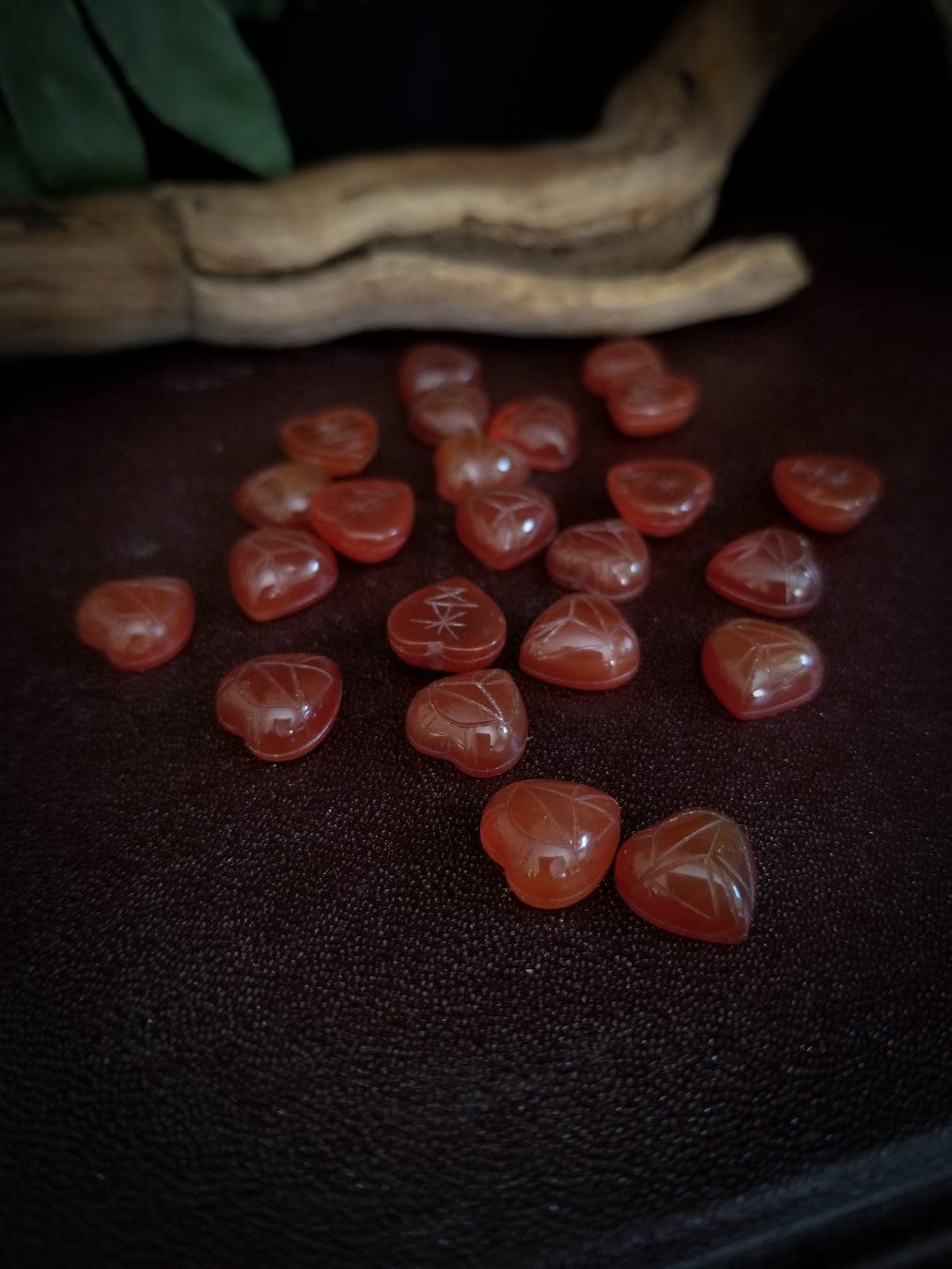 Red carnelian heart cabochons with carved scarab beetle designs.