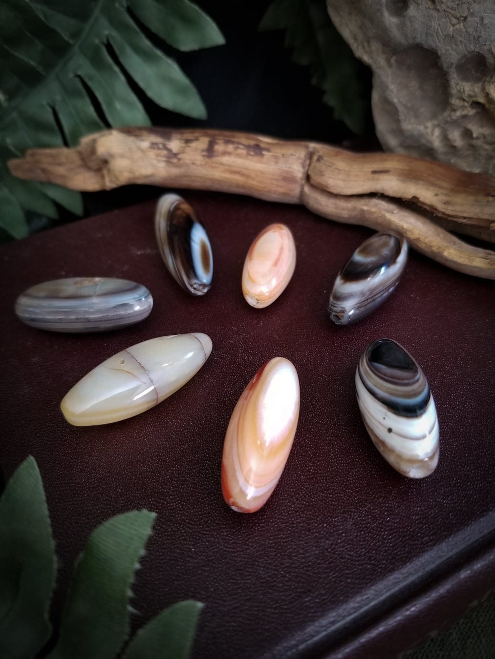 7 Smooth tube banded agate stone beads. Colors - red, white, and black bands.