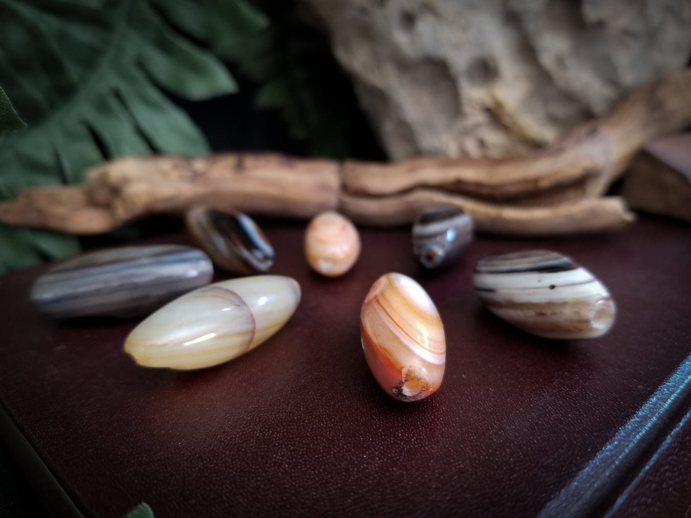 7 Smooth tube banded agate stone beads. Colors - red, white, and black bands.