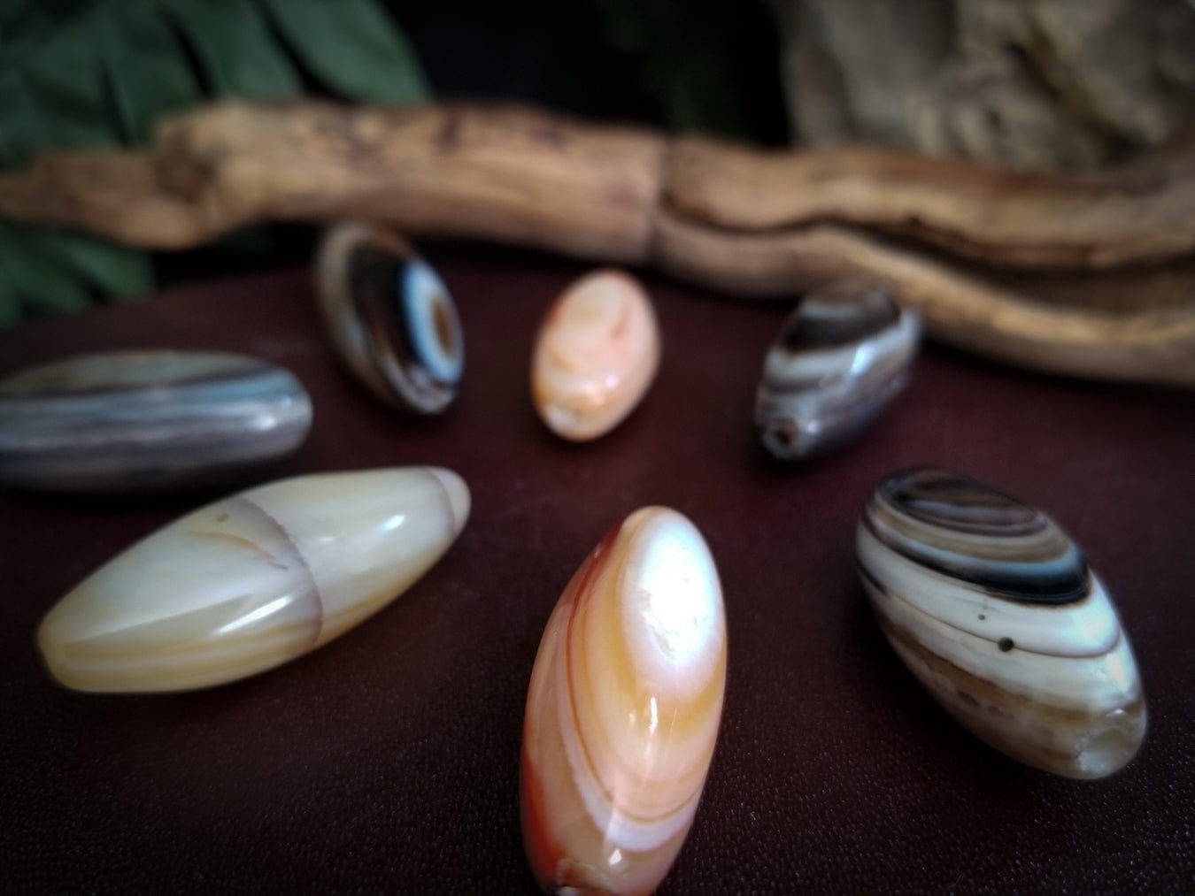 7 Smooth tube banded agate stone beads. Colors - red, white, and black bands.