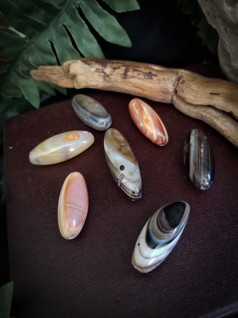 7 Smooth tube banded agate stone beads. Colors - red, white, and black bands.