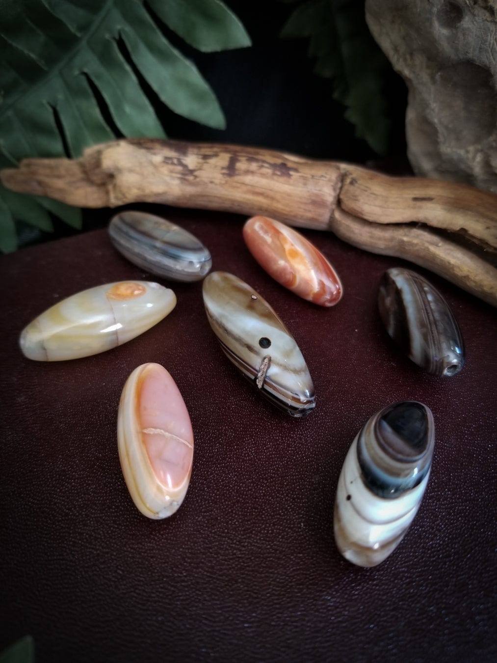 7 Smooth tube banded agate stone beads. Colors - red, white, and black bands.
