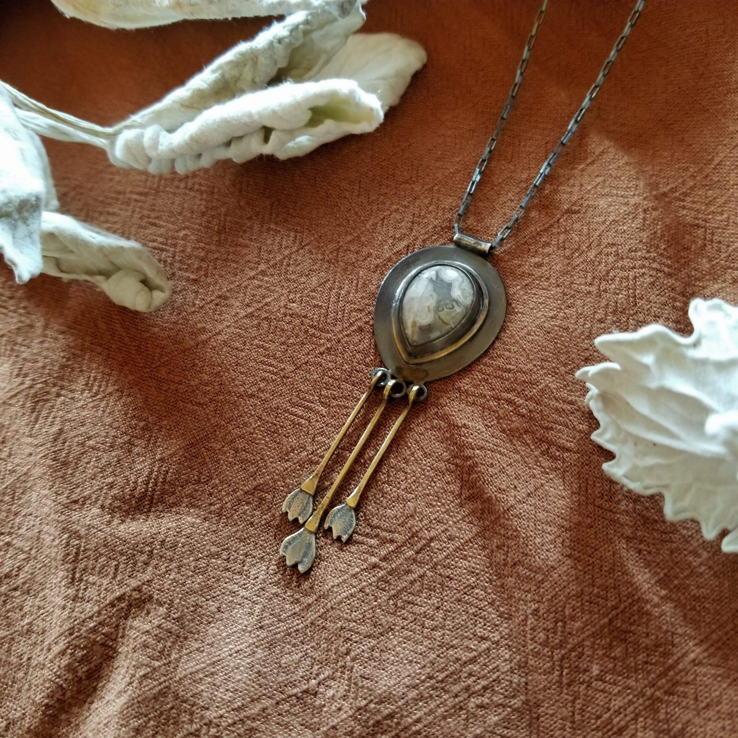 Snowdrop Necklace No. 1 - Teardrop shape Mexican Agate set in sterling silver and brass with 3 individual hand engraved snowdrop flowers hanging from brass fringe. All hanging from a sterling silver box chain.