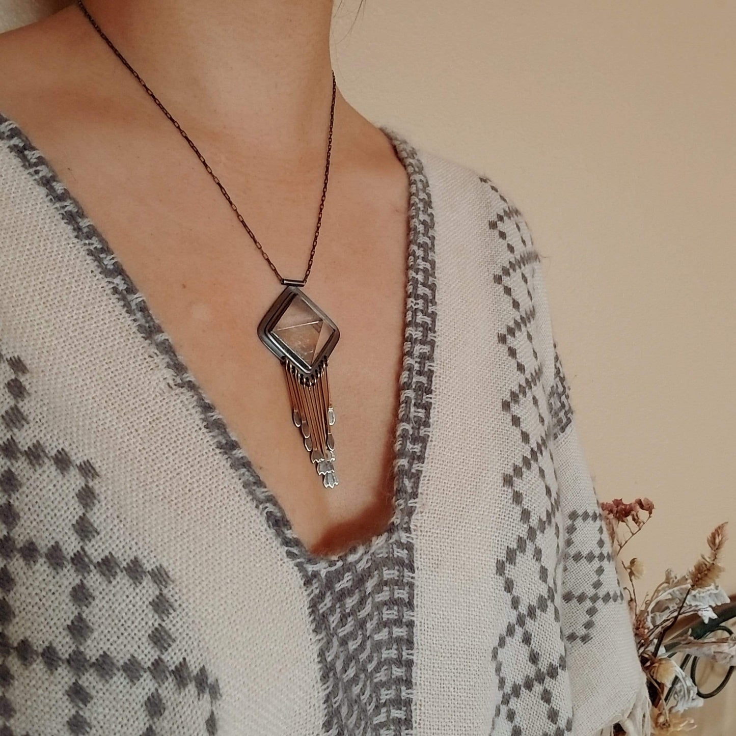 Handmade one of a kind necklace with rutilated quartz set in sterling silver and brass with eleven hand engraved snowdrop flower fringe dangles. All hanging on a sterling silver chain.