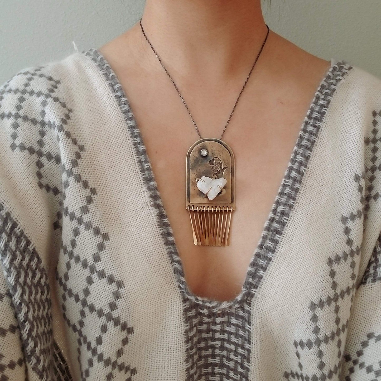 Handmade one of a kind necklace. Arch shaped brass with hand pierced snowdrop emerging from the snow under the full moon. The organic shaped druzy agate represents the snow and the mother of pearl round cabochon represents the moon.