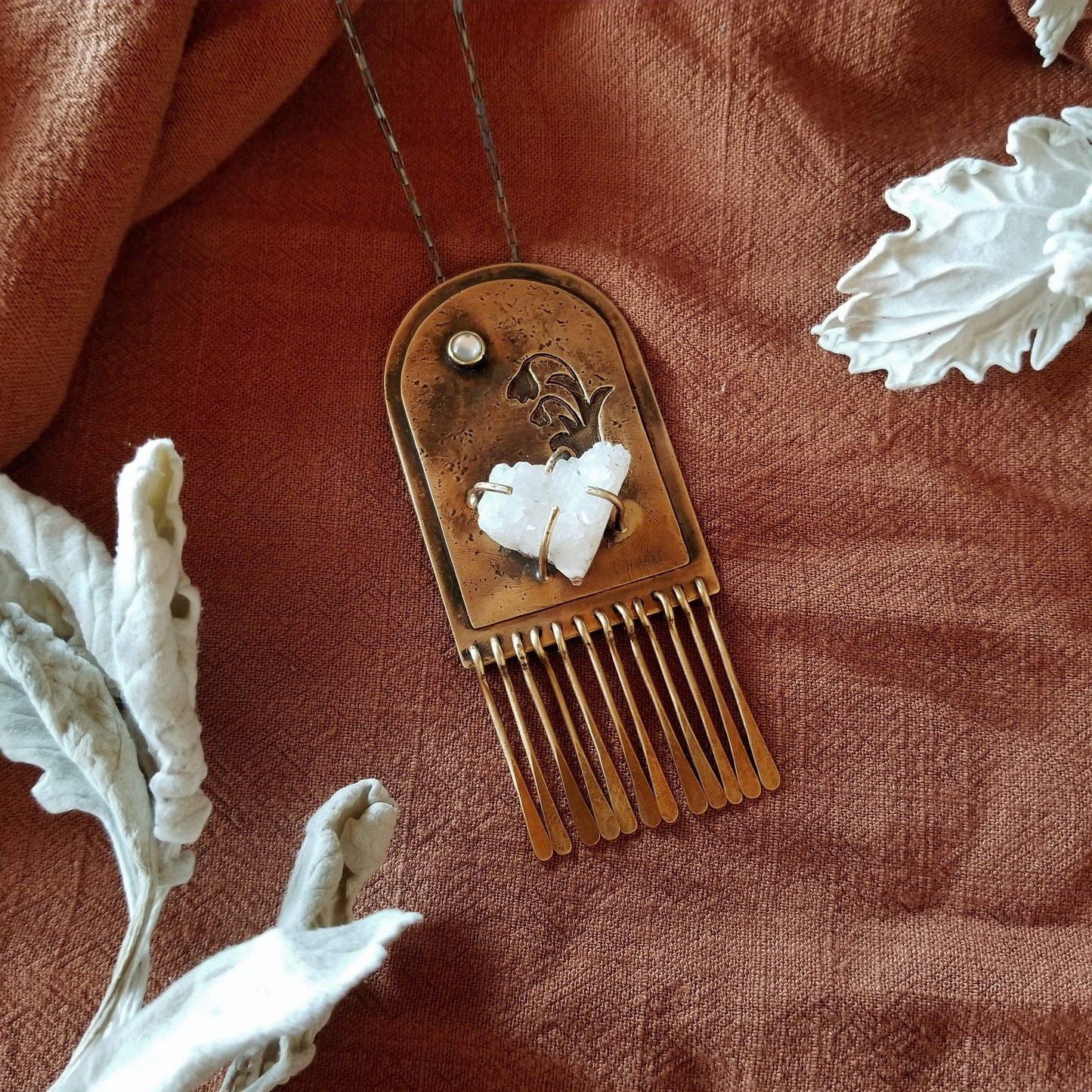 Handmade one of a kind necklace. Arch shaped brass with hand pierced snowdrop emerging from the snow under the full moon. The organic shaped druzy agate represents the snow and the mother of pearl round cabochon represents the moon.