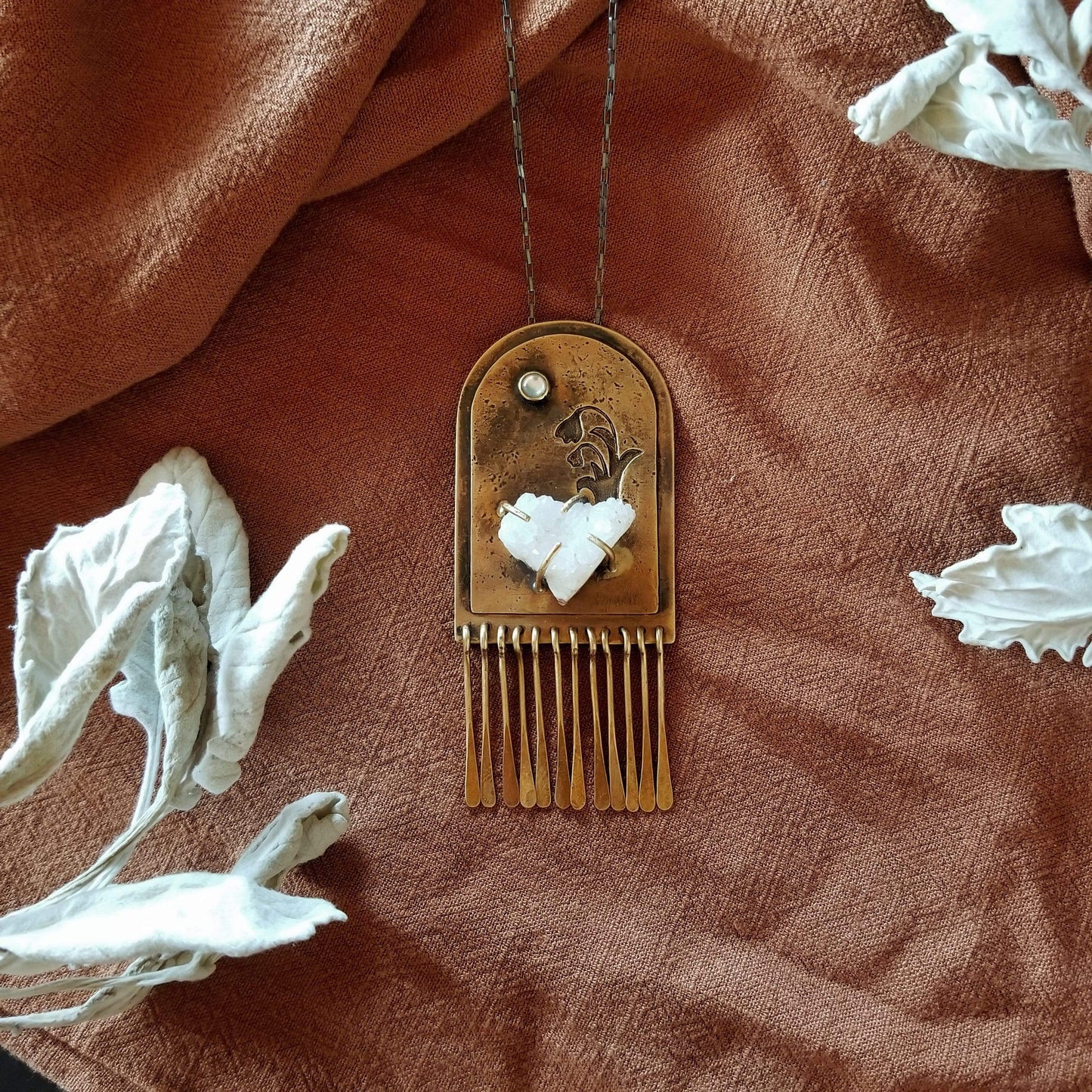 Handmade one of a kind necklace. Arch shaped brass with hand pierced snowdrop emerging from the snow under the full moon. The organic shaped druzy agate represents the snow and the mother of pearl round cabochon represents the moon.