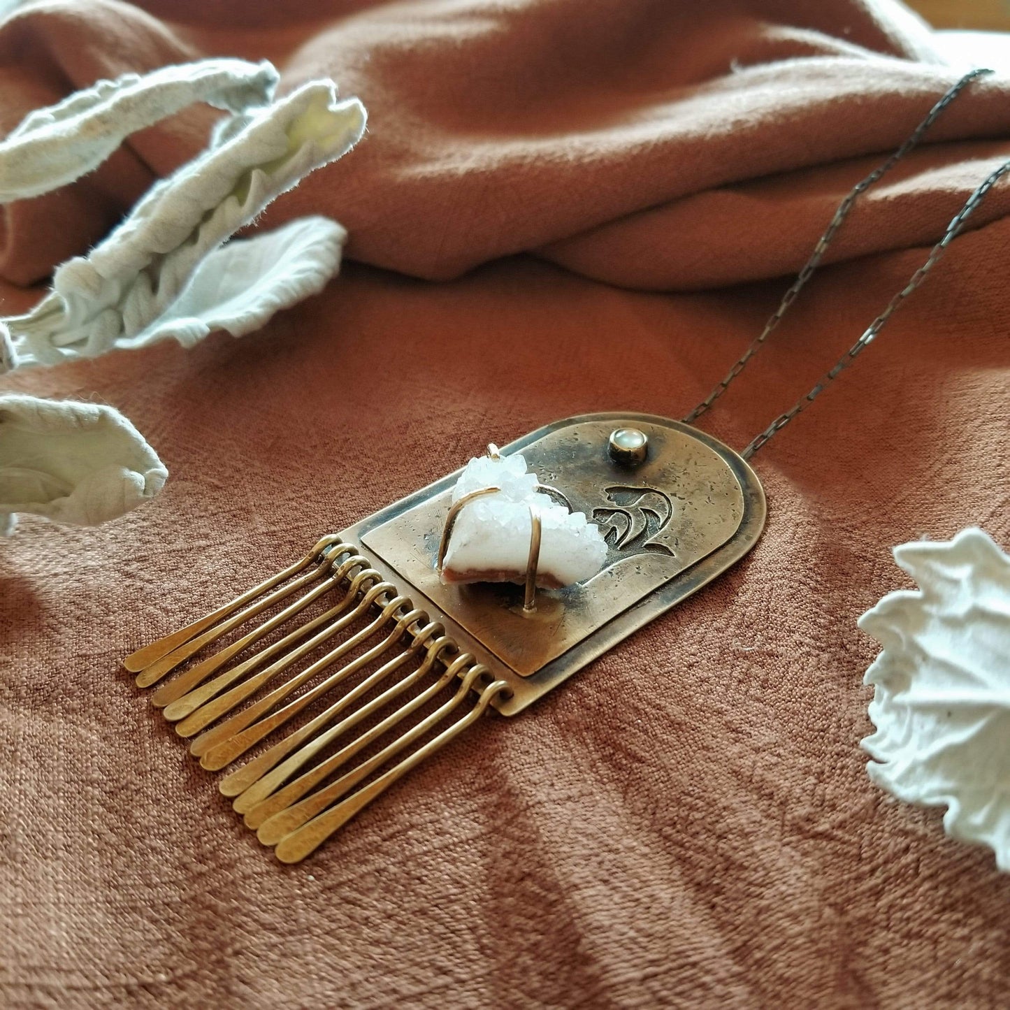 Handmade one of a kind necklace. Arch shaped brass with hand pierced snowdrop emerging from the snow under the full moon. The organic shaped druzy agate represents the snow and the mother of pearl round cabochon represents the moon.