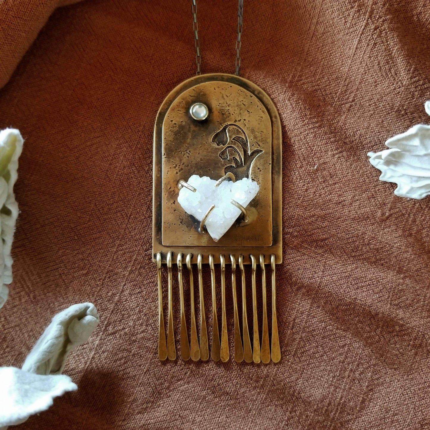 Handmade one of a kind necklace. Arch shaped brass with hand pierced snowdrop emerging from the snow under the full moon. The organic shaped druzy agate represents the snow and the mother of pearl round cabochon represents the moon.