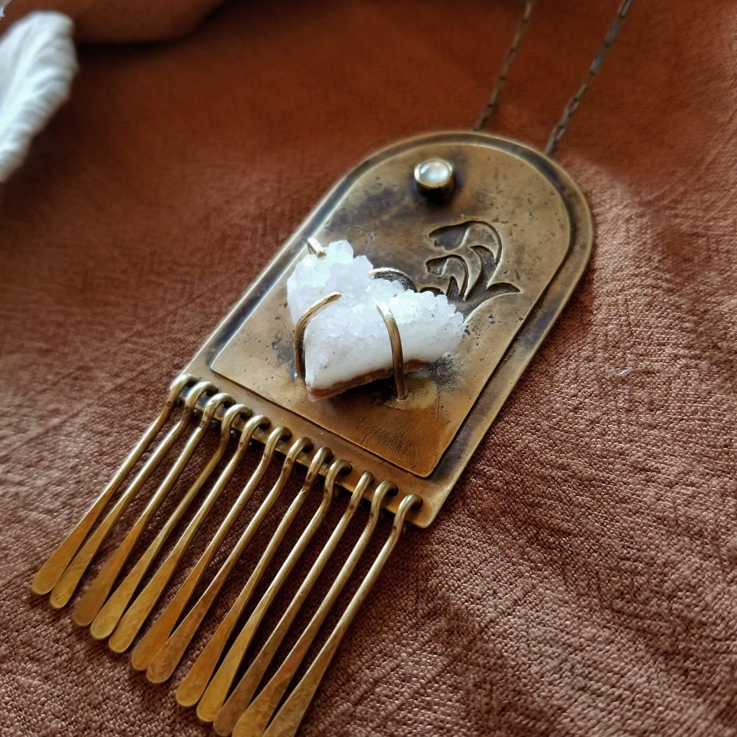 Handmade one of a kind necklace. Arch shaped brass with hand pierced snowdrop emerging from the snow under the full moon. The organic shaped druzy agate represents the snow and the mother of pearl round cabochon represents the moon.
