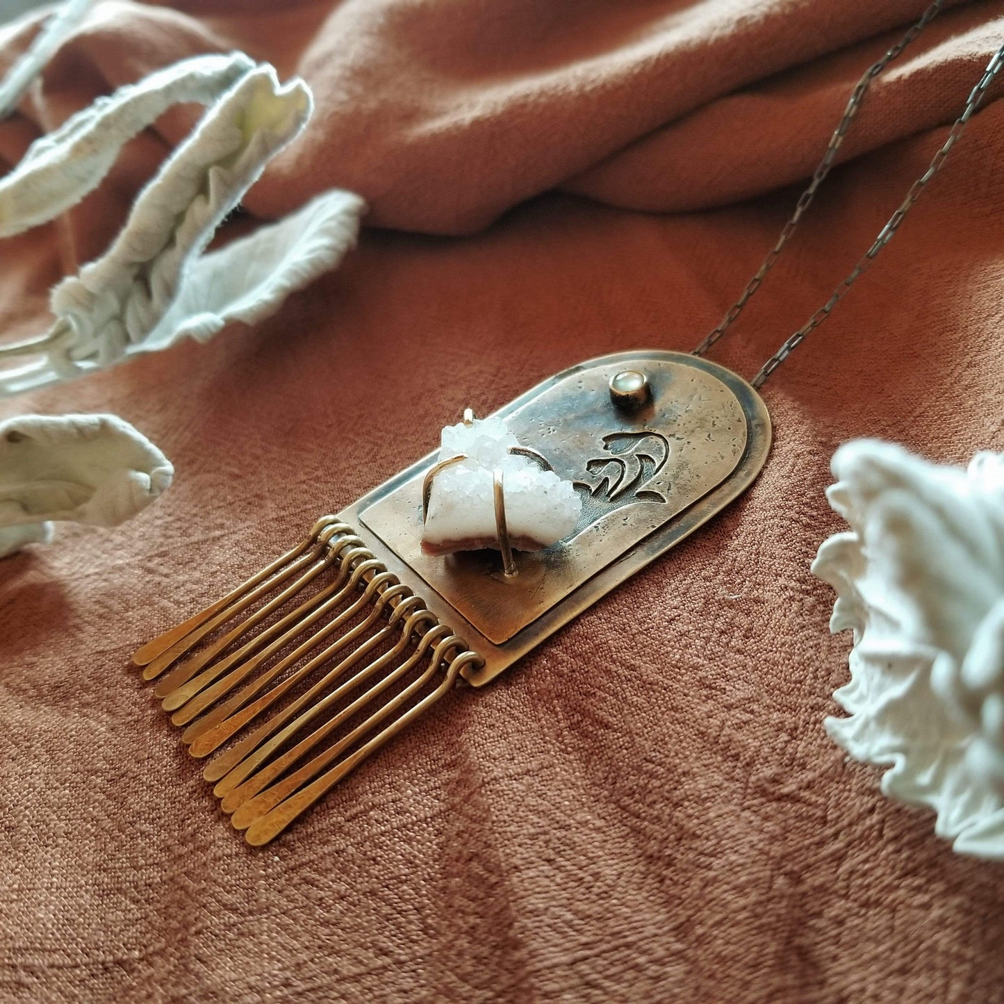 Handmade one of a kind necklace. Arch shaped brass with hand pierced snowdrop emerging from the snow under the full moon. The organic shaped druzy agate represents the snow and the mother of pearl round cabochon represents the moon.