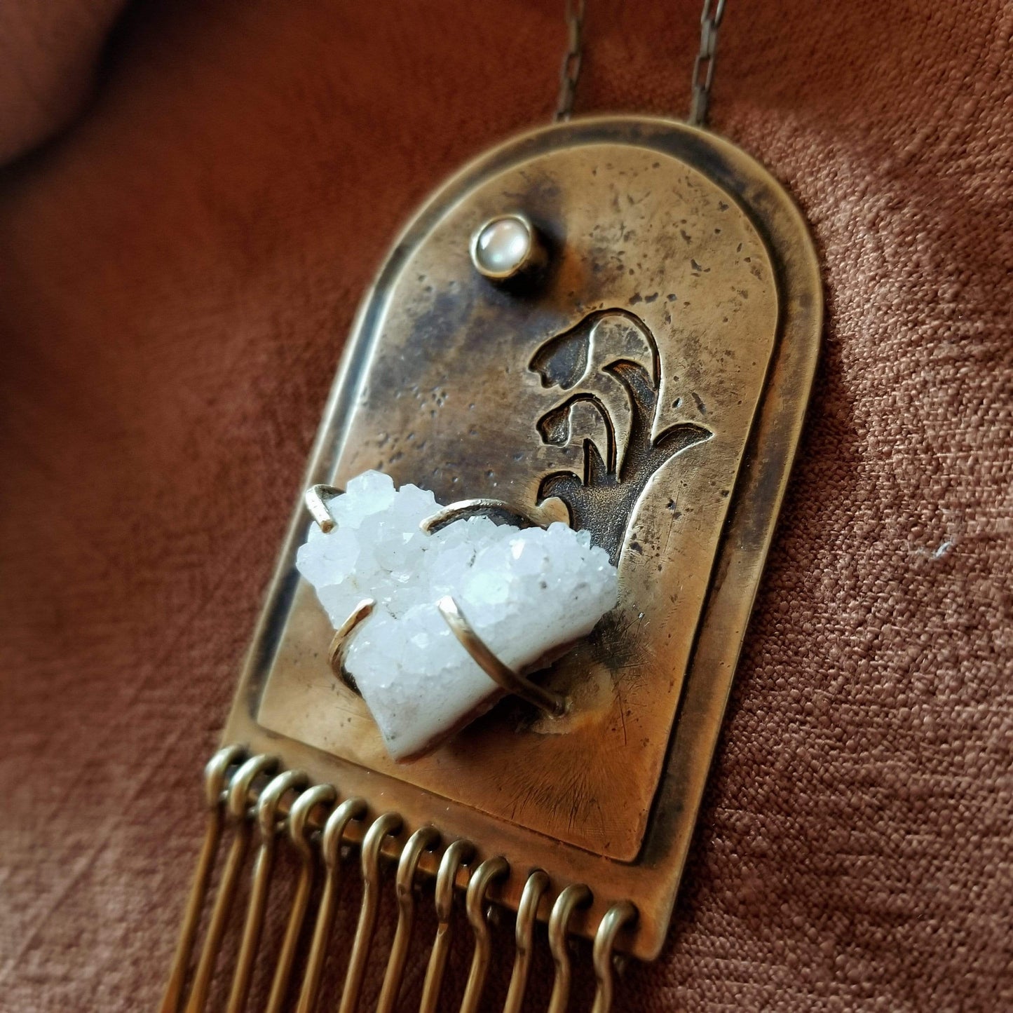 Handmade one of a kind necklace. Arch shaped brass with hand pierced snowdrop emerging from the snow under the full moon. The organic shaped druzy agate represents the snow and the mother of pearl round cabochon represents the moon.