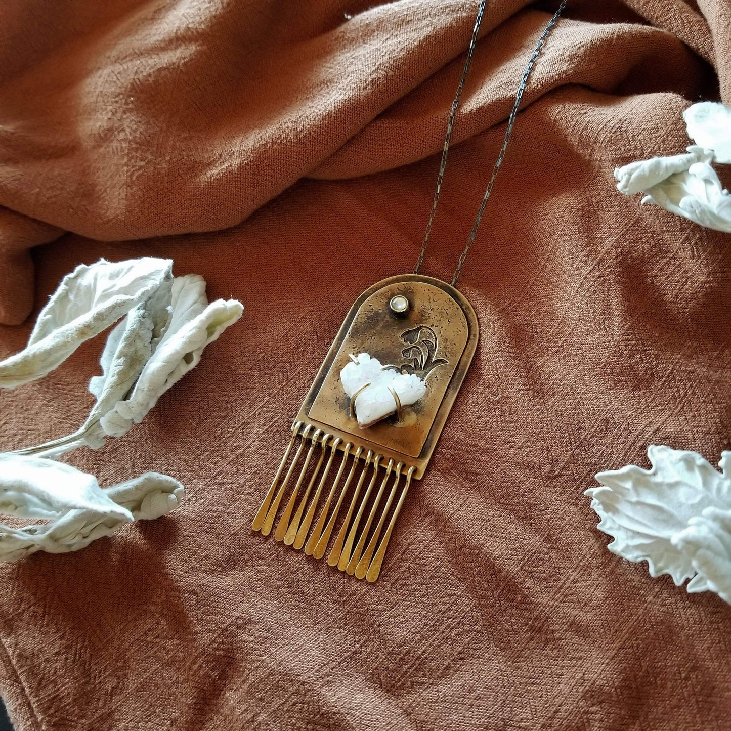 Handmade one of a kind necklace. Arch shaped brass with hand pierced snowdrop emerging from the snow under the full moon. The organic shaped druzy agate represents the snow and the mother of pearl round cabochon represents the moon.