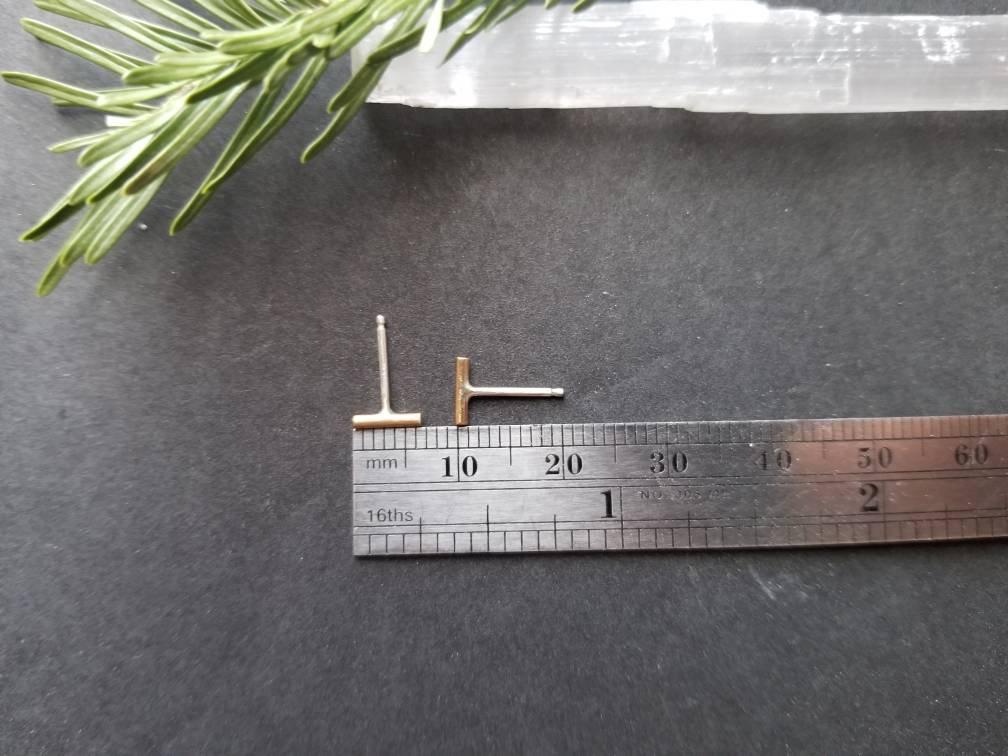 Showing measurements of handmade brass bar studs with sterling silver posts. Brass bars measure ¼ inches in length.