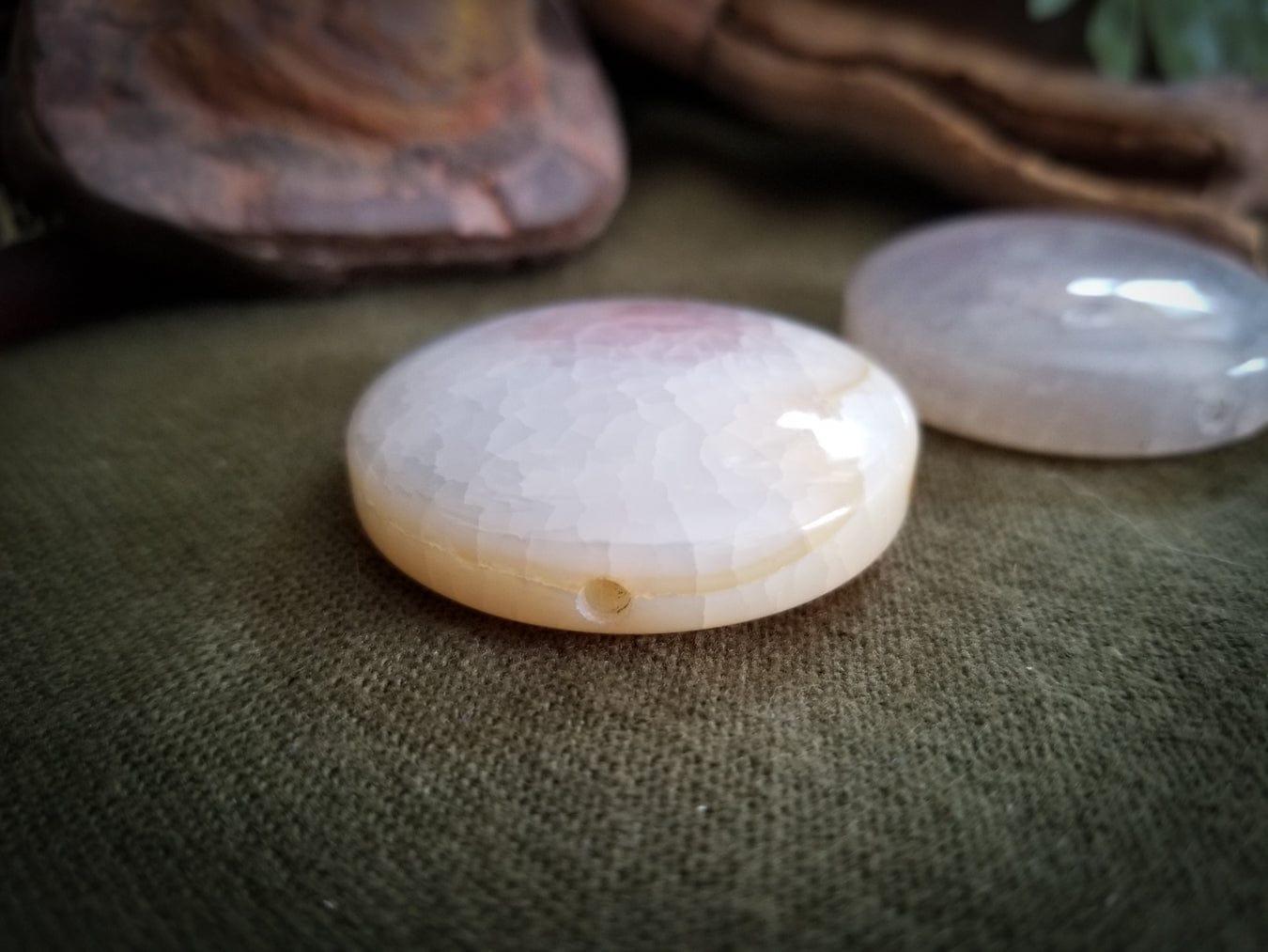 2 Flat Round Agate beads. Color - translucent with tones of white, pink, and pale yellow. Smooth with a cracked effect created by heat.