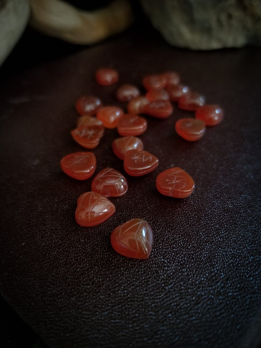 Red carnelian heart cabochons with carved scarab beetle designs.