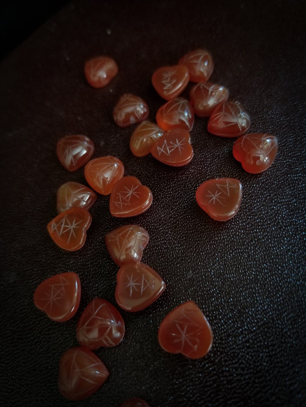 Red carnelian heart cabochons with carved scarab beetle designs.