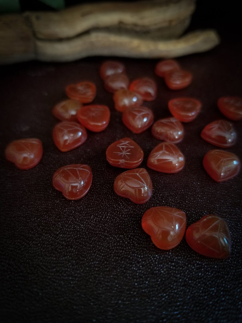 Red carnelian heart cabochons with carved scarab beetle designs.